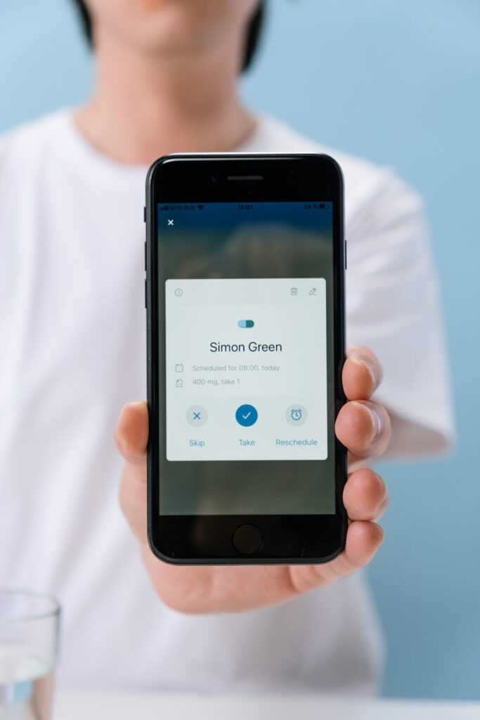 person holding black mobile phone with health app on the screen